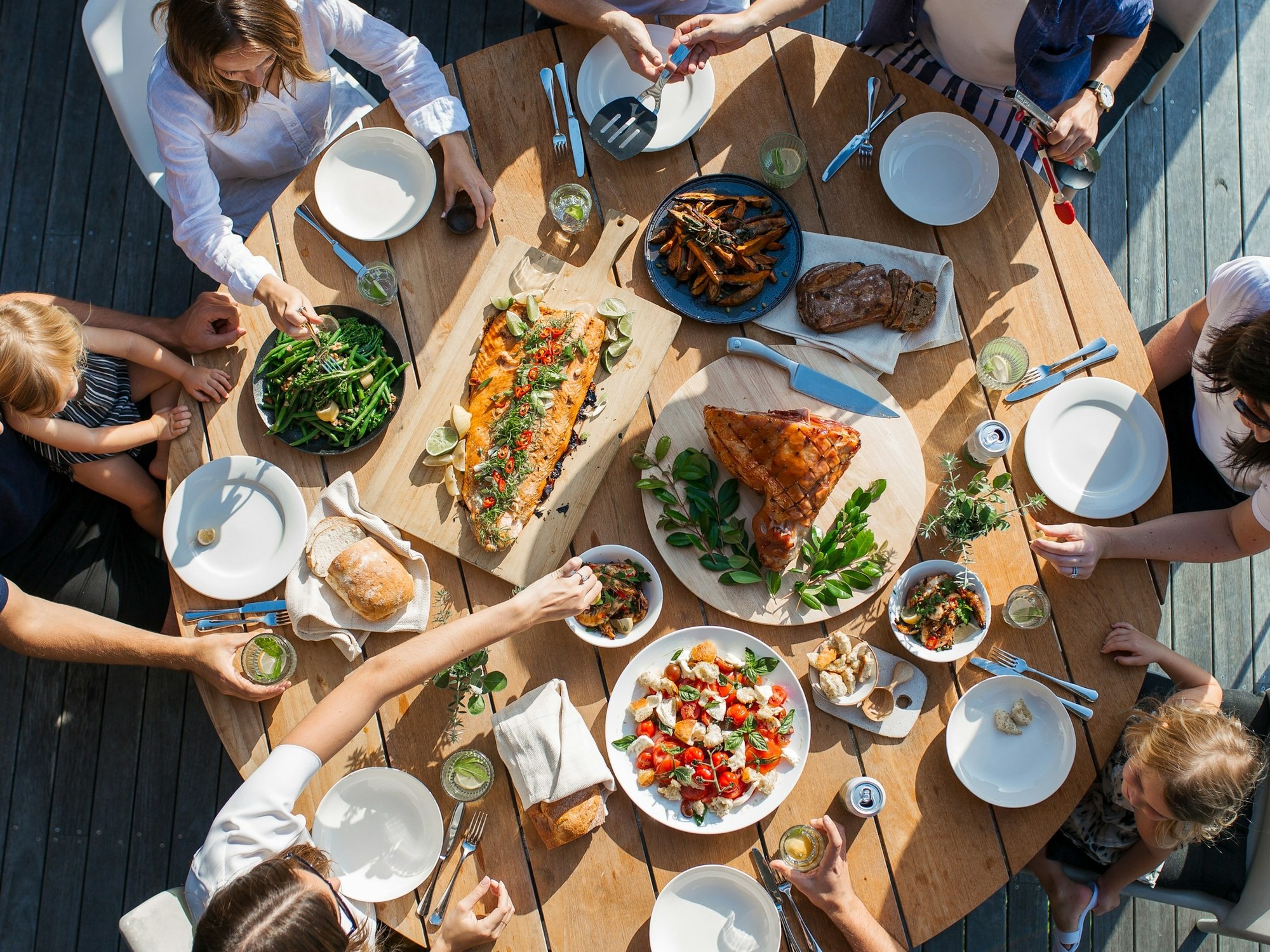 People sharing a table full of food